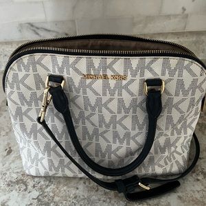 A white a navy blue Michael kors could be use as a cross body